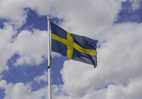 low-angle-view-flag-against-cloudy-sky
