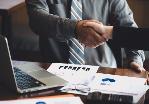 midsection-businessman-colleague-shaking-hands