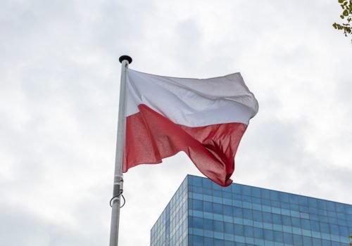 Poland flag. Polish flag on a pole waving, modern office building background